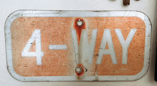 Faded Red Four Way Sign